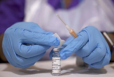 A medical worker prepares an injection of AstraZeneca's coronavirus vaccine in Baitul Futuh Mosque, London, in March. Photo: Reuters