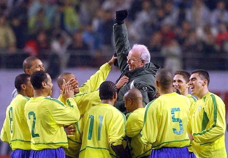 Brazilian players toss Mario Zagallo in the air at the end of a friendly match with South Korea in Seoul in 2002. AFP