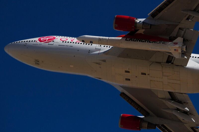 The Virgin Orbit "Cosmic Girl" - a modified Boeing Co. 747-400 carrying a LauncherOne rocket under it's wing - takes off for the Launch Demo 2 mission from Mojave Air and Space Port on January 17, 2021 in Mojave, California.  The LauncherOne rocket, which will release from the wing of the Boeing 747 before ignition, contains small research satellites, known as CubeSats for NASA's Educational Launch of Nanosatellites (ELaNa) 20 mission developed by nine research universities and a NASA center. / AFP / Patrick T. FALLON
