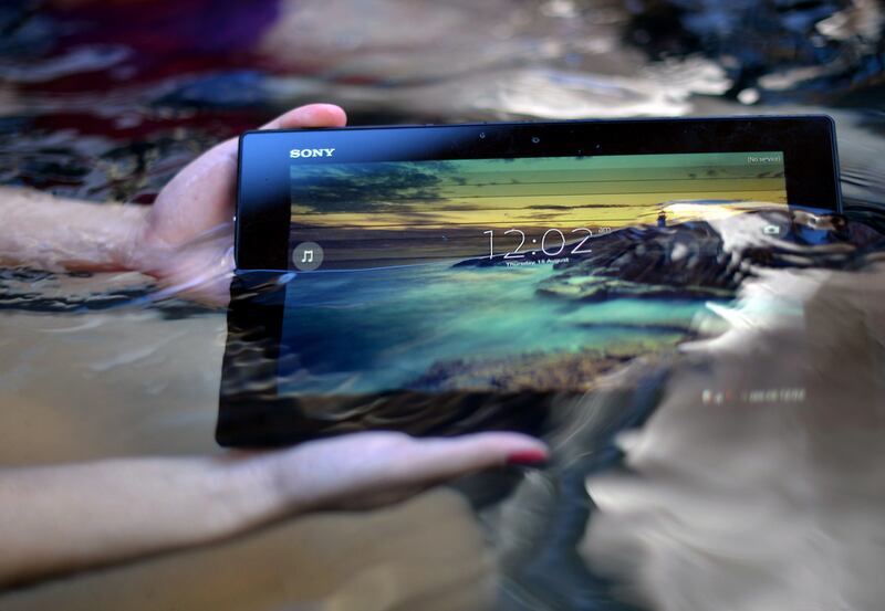 Sony’s Xperia Tablet Z, which can work a metre under water, gets a soaking. Saeed Khan / AFP
