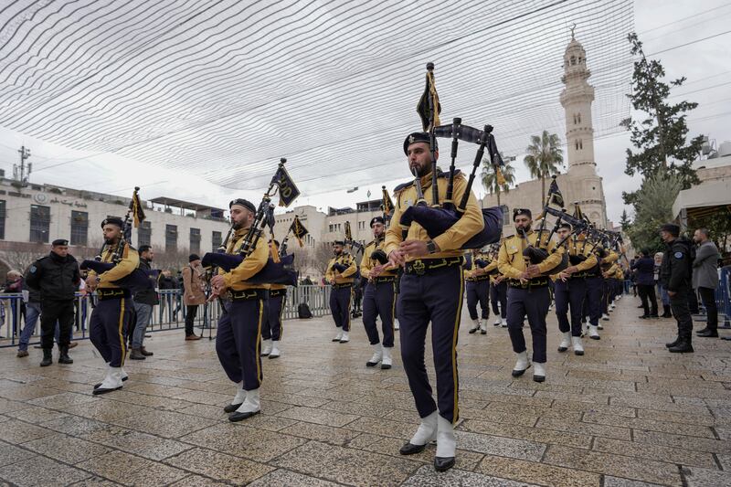 Palestinian scout band pipers perform in Manger Square. Bethlehem is facing its second Christmas hit by the coronavirus, with smaller crowds expected. AP Photo