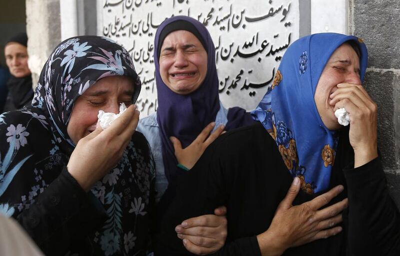 Syrian mourners attend a funeral ceremony on the outskirts of Damascus on April 26, 2017 for the victims of a bombing that targeted buses carrying evacuees from the besieged government-held towns of Fuaa and Kefraya. Louai Beshara / AFP

