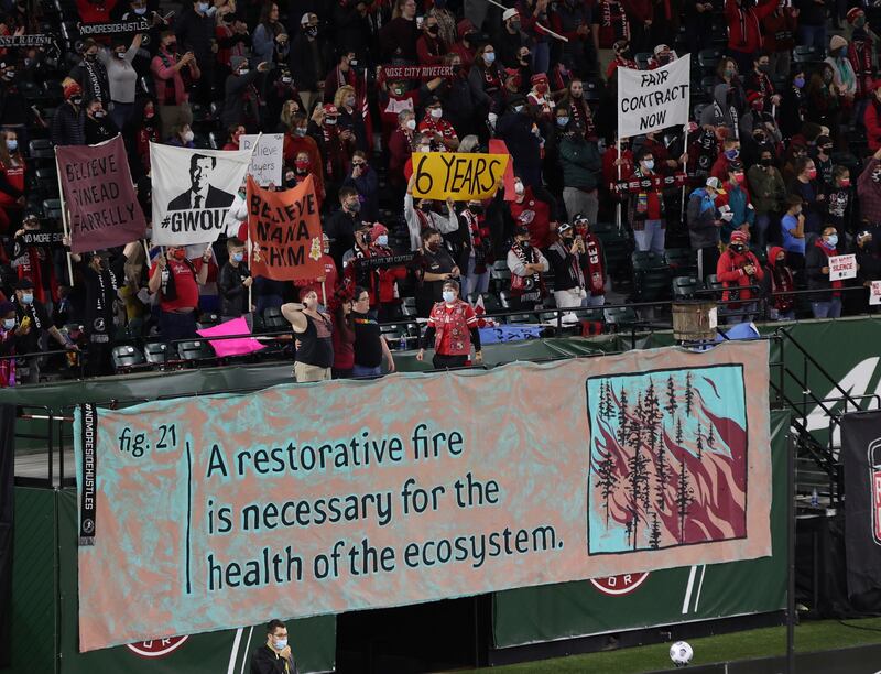 Portland Thorns fans hold signs during the sixth minute of the team's NWSL soccer match against the Houston Dash in Portland, Oregon. AP Photo