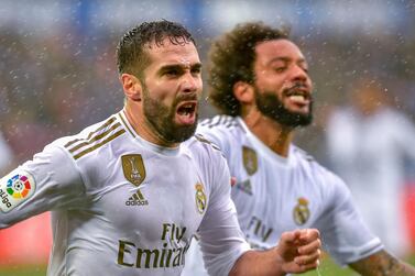 Real Madrid's Spanish defender Daniel Carvajal (L) celebrates after scoring a goal during the Spanish league football match between Deportivo Alaves and Real Madrid CF at the Mendizorroza stadium in Vitoria on November 30, 2019. / AFP / ANDER GILLENEA