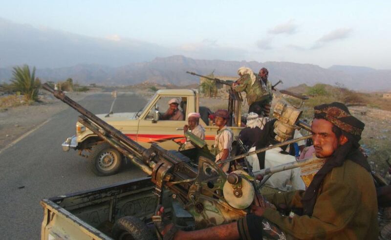 Resistance fighters loyal to the government of Yemeni president Abdrabu Mansur Hadi sit on the back of armed pick up trucks in Taez province's Al Wazeyah district on November 19, 2015. Pro-government forces halted their advance on all fronts in Taez a day later after the Houthis heavily mined roads to the provincial capital. Nabil Hassan/AFP Photo

