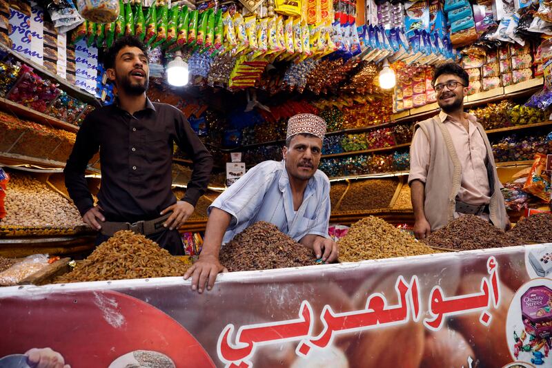 Yemeni sweet sellers wait for customers at a market in Sanaa. EPA