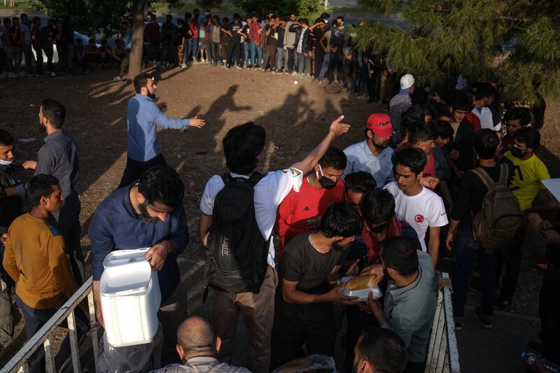 Refugees who arrive to Diyarbakir from Turkish-Iran border fight for donated food near intercity bus station in Diyarbakir, Turkey.