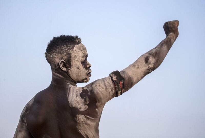 A wrestler raises his fist in the air during a traditional Nuba wrestling competition in Sudan's capital Khartoum.