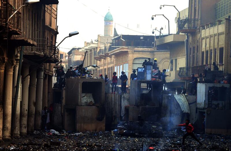 Iraqi protesters clash with anti-riot police forces at the Al Rasheed street in central Baghdad.  EPA