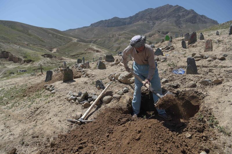 A man digs a grave for one of the 57 victims of a bomb blast before the burial a day after the attack on a voter registration centre in Kabul, on April 23, 2018. Shah Marai / AFP