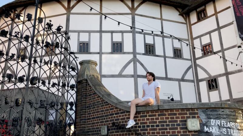 Royal Ballet dancer David Donnelly sits on wall outside the Globe Theatre in London. Reuters