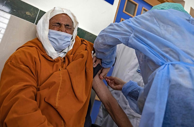 An elderly Moroccan man receives a dose of the COVID-19 vaccine at an inoculation centre in the city of Sale on February 12, 2021, as part of a campaign in the region. A country of 35 million people, Morocco has registered nearly half a million cases of the Covid-19 illness and 8,440 deaths, battering the country's economy and forcing a renewed curfew from December 23. / AFP / FADEL SENNA
