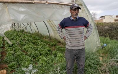 A farmer stands by a greenhouse of lettuce in the Lebanese village of Qab Elias. Matt Kynaston / The National