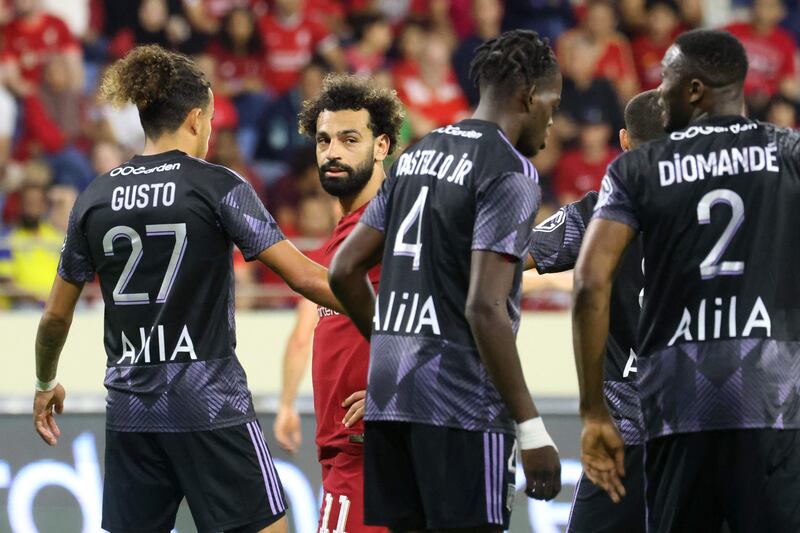 Mohamed Salah watches  as Lyon's players celebrate scoring. AFP
