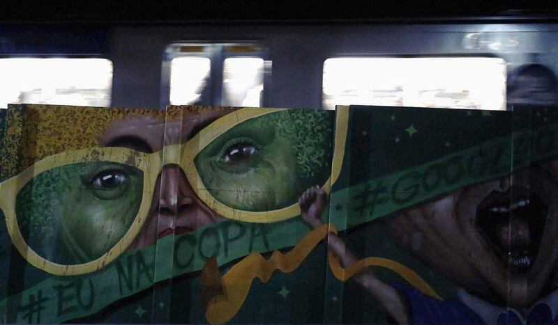 A metro train metro passes by graffiti, painted in reference to the 2014 World Cup, near Sao Paulo's World Cup stadium on Wednesday. Nacho Doce / Reuters / June 4, 2014