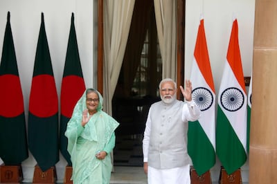 Indian Prime Minister Narendra Modi, right, and his Bangladeshi counterpart Sheikh Hasina wave to the waiting media before their talks in New Delhi on Tuesday. AP