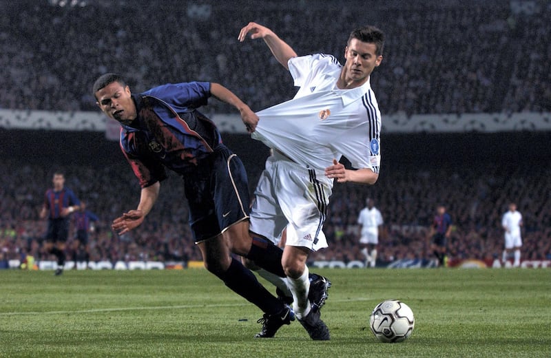 BARCELONA - APRIL 23:  Santiago Solari of Real Madrid has his shirt pulled by Geovanni of Barcelona during the UEFA Champions League semi-final first leg match played at the Nou Camp, in Barcelona, Spain on April 23, 2002. Real Madrid won the match 2-0. DIGITAL IMAGE. (Photo by Clive Brunskill/Getty Images) 