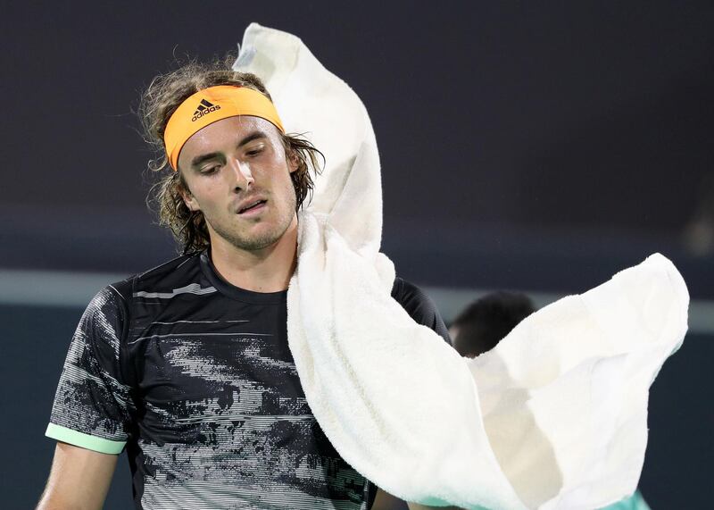 Abu Dhabi, United Arab Emirates - Reporter: Jon Turner: Stefanos Tsitsipas throws his towel on himself during the semi final between Novak Djokovic v Stefanos Tsitsipas at the Mubadala World Tennis Championship. Friday, December 20th, 2019. Zayed Sports City, Abu Dhabi. Chris Whiteoak / The National