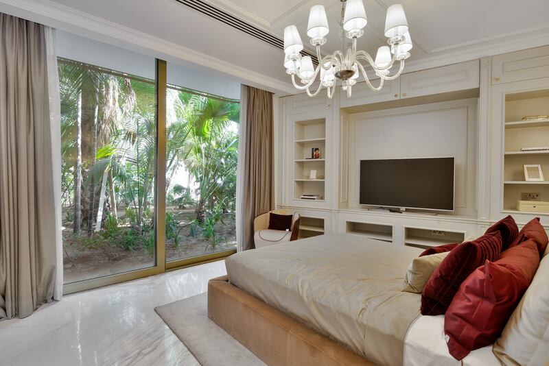 A bedroom with a jungle view