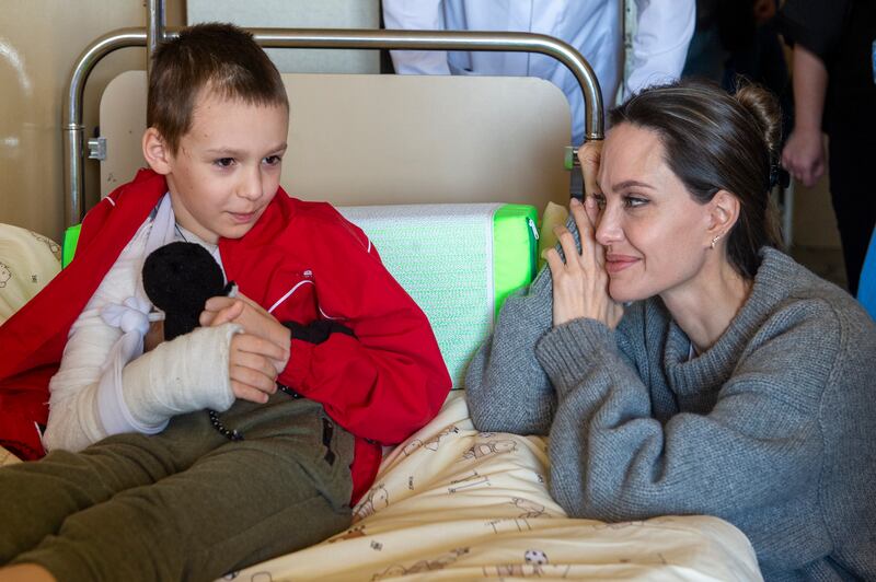 US Actress and UN Goodwill Ambassador Angelina Jolie comforts a young victim of the Kramatorsk railway station missile strike in Lviv children's hospital, in Western Ukraine on April 30, 2022. EPA