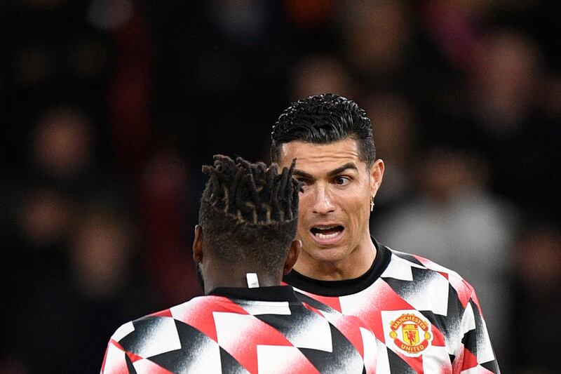 Manchester United's Portuguese striker Cristiano Ronaldo speaks to teammate Fred during the warm up. AFP