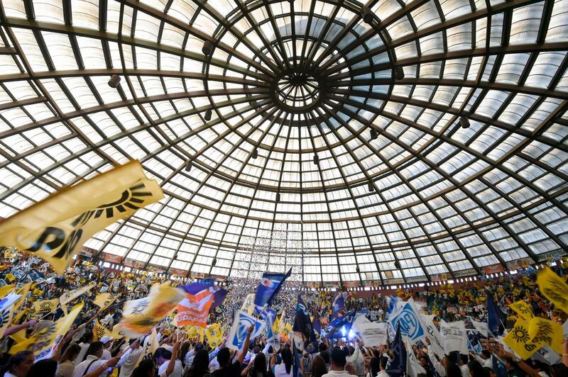 Supporters of Mexico's presidential candidate Ricardo Anaya, who is standing for the "Mexico al Frente" coalition of the PAN-PRD parties, cheer during a campaign rally at the Palacio del Arte in Morelia, Michoacan State, Mexico. Alfredo Estrella / AFP