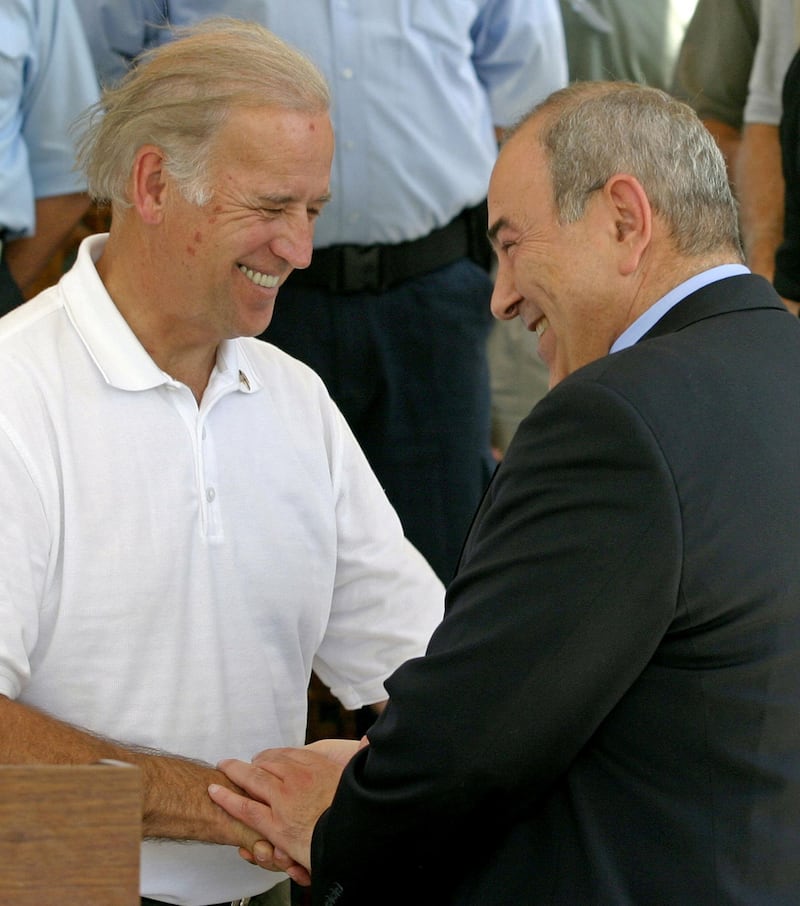 US senator Joseph Biden is greeted by Iraq's interim Prime Minister Iyad Allawi while visiting Baghdad 19 June 2004. Eighteen Iraqis were killed and eight wounded in the Sunni rebel stronghold of Fallujah, hospital officials said, in an attack which local residents blamed on a US air raid.  AFP PHOTO/POOL/Ceerwan AZIZ (Photo by CEERWAN AZIZ / POOL / AFP)