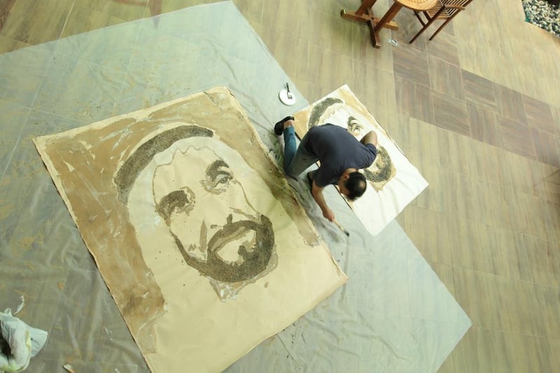 Sylvain Tremblay practising for his portrait of Sheikh Zayed created in sand. Courtesy Canadian University of Dubai