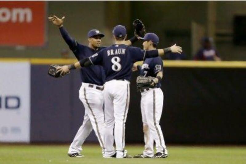 The Milwaukee Brewers’ Carlos Gomez, left, Ryan Braun, centre, and Norichika Aoki celebrate beating the Atlanta Braves on Monday, during their recent run of 18 wins from 23 games.