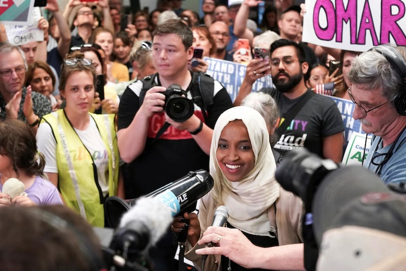 U.S. Rep. Ilhan Omar speaks to supporters as she arrives at Minneapolisâ€“Saint Paul International Airport, Thursday, July 18, 2019, in Minnesota. President Donald Trump is chiding campaign supporters who'd chanted "send her back" about Somali-born Omar, whose loyalty he's challenged. (Glen Stubbe/Star Tribune via AP)