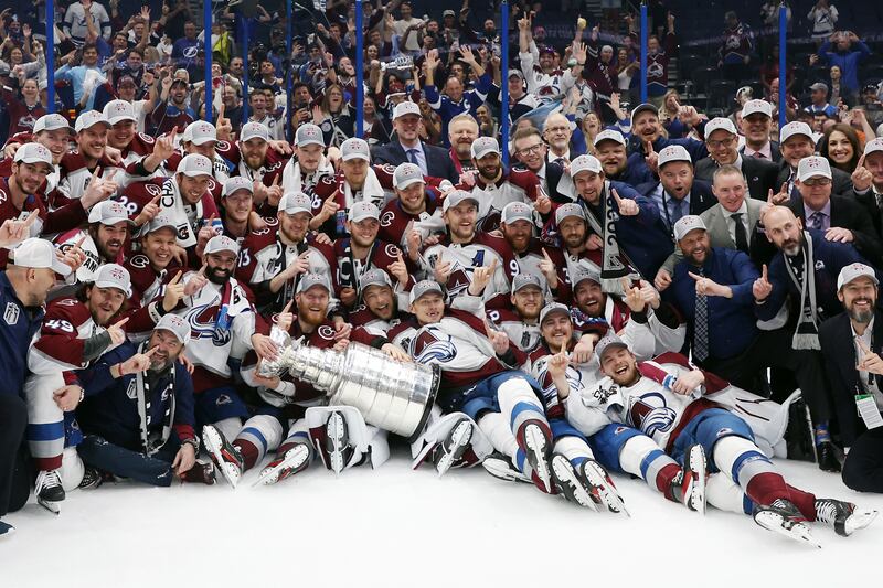 Colorado Avalanche coaches and players pose for a photo after defeating the Tampa Bay Lightning 2-1 in Game Six of the 2022 NHL Stanley Cup Final. AFP
