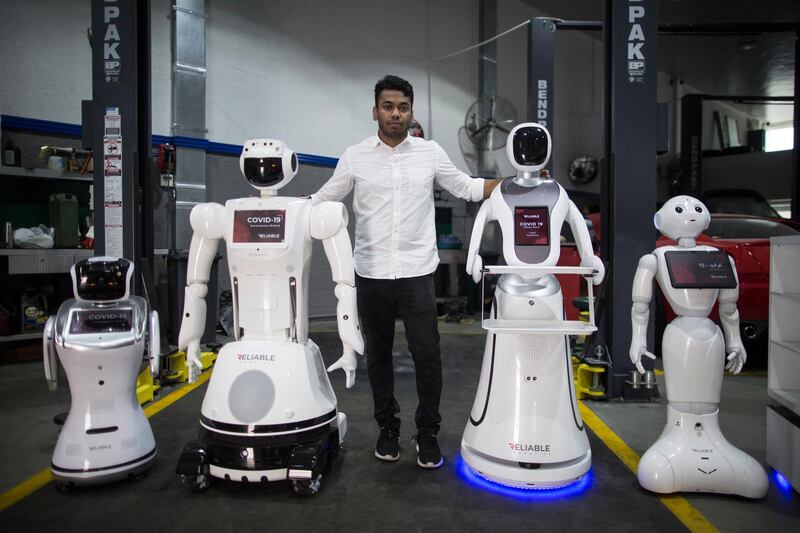 Aswin Sarang, head of Reliable Robotics company, stands with a fever detection and hand sanitiser dispenser robot in Dubai. Before the pandemic, the company had been renting the robots out for events to welcome guests, but since the Covid-19 outbreak, Reliable Robotics has used its technology to help fight the spread of coronavirus. EPA