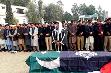 Pakistani villagers offer funeral prayers for killed police officers in Lower Dir, Pakistan. AP