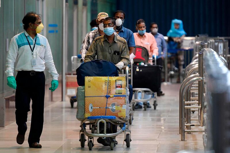 Indian citizens arriving from Dubai by an Air India flight, arrive at the Anna International Airport as part of a massive repatriation effort, in Chennai on May 9, 2020. AFP