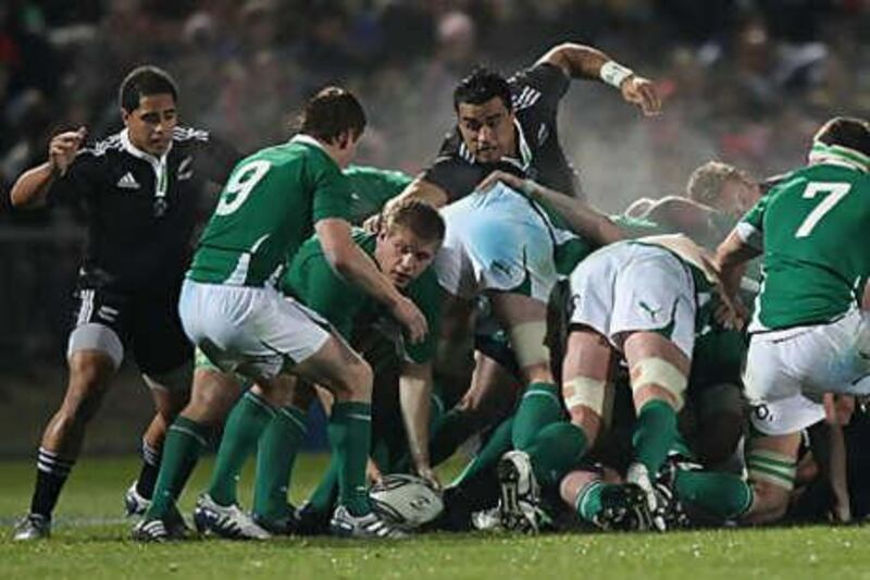 Liam Messam of NZ Maori reaches for Chris Henry of Ireland as he passes out  of the scrum.