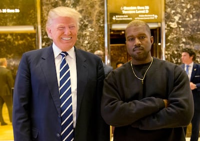 FILE - In this Dec. 13, 2016, file photo, President-elect Donald Trump and Kanye West pose for a picture in the lobby of Trump Tower in New York.  Kanye West will visit the White House on Thursday to meet with President Donald Trump and his son-in-law Jared Kushner talk about manufacturing in America, gang violence, prison reform and Chicago violence. (AP Photo/Seth Wenig, File)