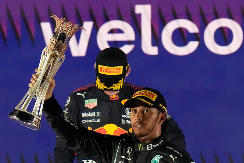 Mercedes driver Lewis Hamilton celebrates winning the Formula One Saudi Arabian Grand Prix, with second placed Red Bull's Max Verstappen in the background, on Sunday, December  5, 2021. AP
