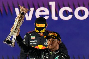 Mercedes driver Lewis Hamilton of Britain celebrates winning the Formula One Saudi Arabian Grand Prix in front of the second placed Red Bull driver Max Verstappen of the Netherlands, in Jiddah, Sunday, Dec.  5, 2021.  (AP Photo / Hassan Ammar)