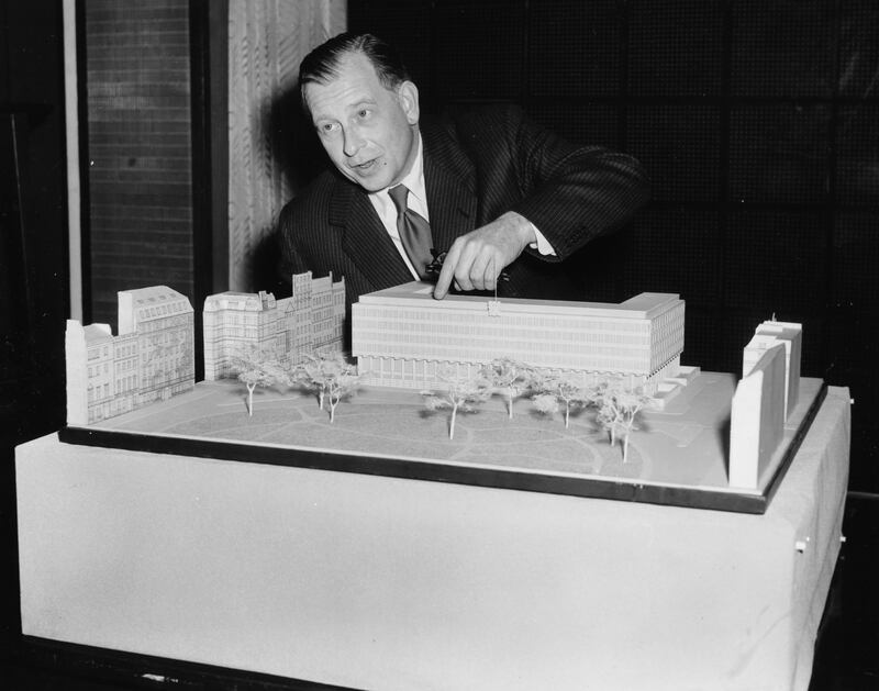 Architect Eero Saarinen with the model for his new US Embassy building in London, in 1956. Getty Images