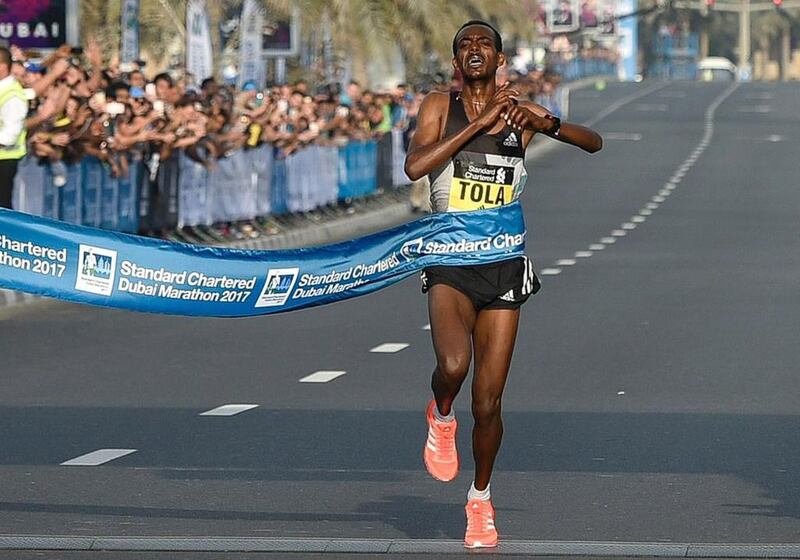 The Ethiopian runner Tamirat Tola crosses the finish line to win the men’s marathon in Dubai in January 2017. AFP