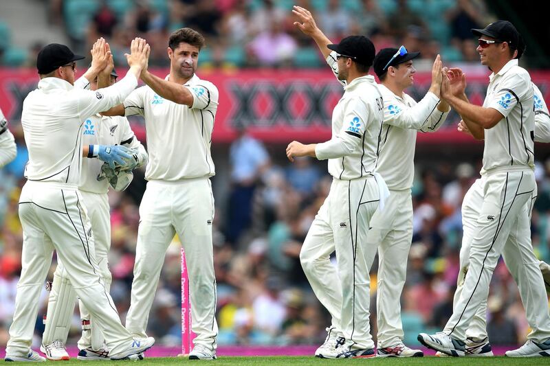 New Zealand bowler Colin de Grandhomme, second left, celebrates with teammates after taking the wicket of Joe Burns. EPA