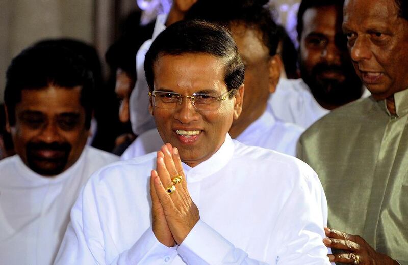 Sri Lanka's newly-elected president Maithripala Sirisena gestures after being sworn in at Independence Square in Colombo (AFP PHOTO / ISHARA S. KODIKARA)

