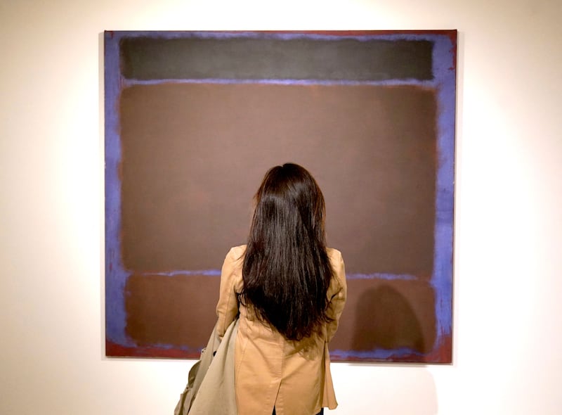 A person poses in front of Mark Rothko’s 'Untitled' during the New York press preview on May 6, 2022 for the Macklowe Collection at Sotheby's. AFP