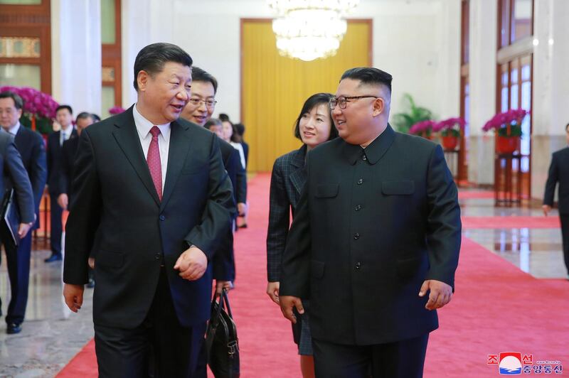 Kim Jong-un, right, walks with Chinese president Xi Jinping during their meeting in Beijing, China. KCNA / EPA