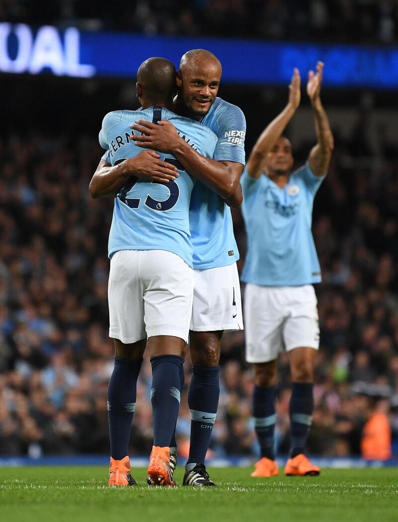 MANCHESTER, ENGLAND - MAY 09:  Fernandinho of Manchester City celebrates with Vincent Kompany of Manchester City after scoring his sides third goal during the Premier League match between Manchester City and Brighton and Hove Albion at Etihad Stadium on May 9, 2018 in Manchester, England.  (Photo by Gareth Copley/Getty Images)