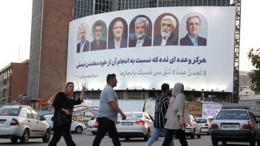 A billboard featuring presidential candidates is displayed on a street in Tehran. Reuters