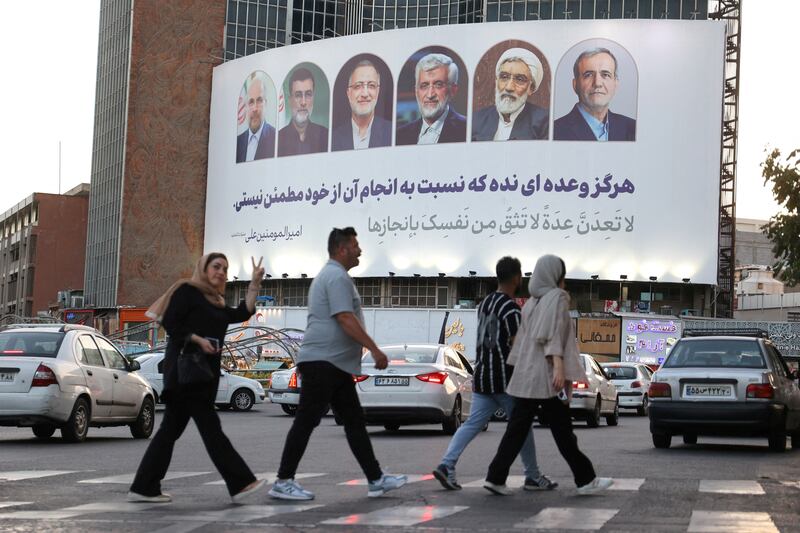 A billboard featuring presidential candidates is displayed on a street in Tehran. Reuters