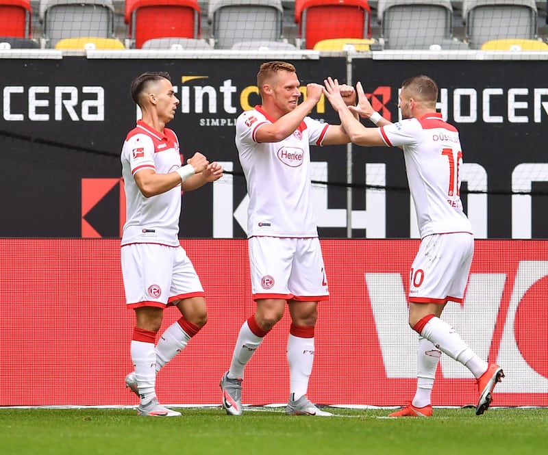 Dusseldorf's Rouwen Hennings, centre, celebrates with teammates after scoring his first goal. EPA