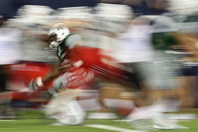 Running back Paul Harris, number six of the Hawaii Warriors, rushes the football against the Arizona Wildcats during the thrid quarter of the college football game at Arizona Stadium. Christian Petersen / Getty Images / AFP