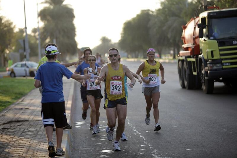 Half-Marathon and 10k runners race around the Abu Dhabi Equestrian Club. Nicole Hill / The National